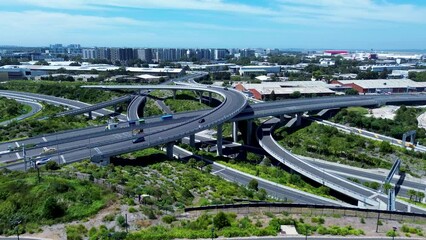 Drone aerial pan of roads cars driving on overpass bridge near Sydney airport CBD skyline Alexandria Tempe infrastructure Australia