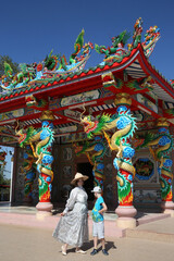 Tourist people: child, kid with fashion woman. Chinese temple near Udon Thani city, Thailand....