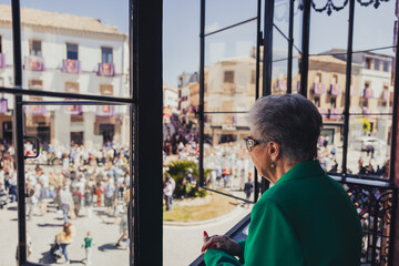Woman watching Holy Week procession, holy week concept