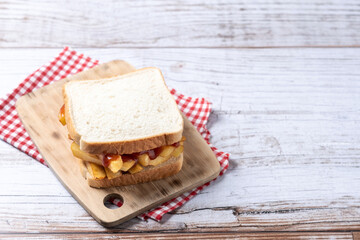 Traditional British chip butty (french fry sandwich) on wooden table