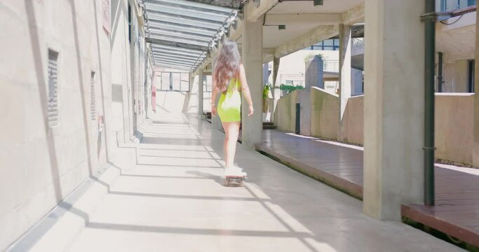 Happy couple playing skateboard enjoy in the outdoor.