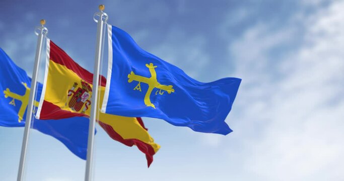 The Asturias flags waving with Spanish flag on a clear day