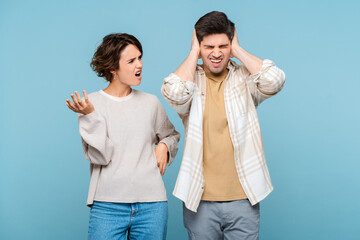 Portrait of couple arguing, angry displeased woman and man yelling at each other and gesturing