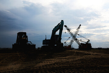 Excavator and cranes silhouette 