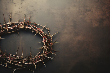 Crown of thorns with long spikes on aged rustic vintage background, top view, symbol of Good...