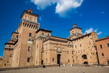 Fototapeta premium Ferrara, Emilia Romagna, Italy. The imposing Estense castle, built by the noble Este family, with its towers and moat full of water. UNESCO World Heritage Site.