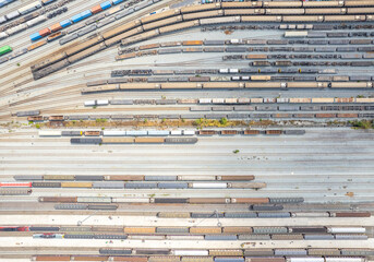 Aerial top view Passenger and freight trains on the railway yard for transportation background. wagons with goods on railroad.