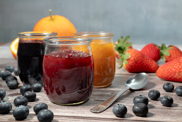 Homemade strawberries marmalade, assortment of homemade jams in glass jars. Front view, seasonal...