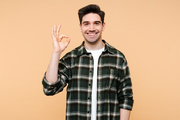 Fototapeta premium Portrait of attractive stylish man wearing stylish hipster outfit showing ok sign