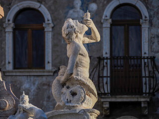 Neptune fountain in Dome place in front of the Medieval Cathedral of San Vigilio in Trento , Italy