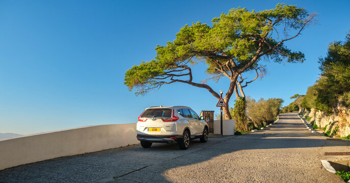 Honda CR-V Adventure: Compact SUV parked on scenic mountain road under captivating blue sky in Gibraltar.