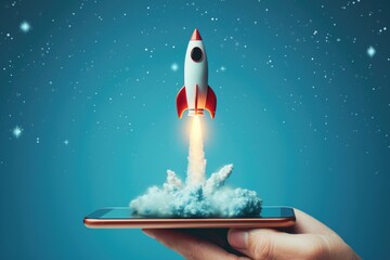 Hand holding cell phone and rocket taking off from the screen, startup, technology and business concept, blue background.
