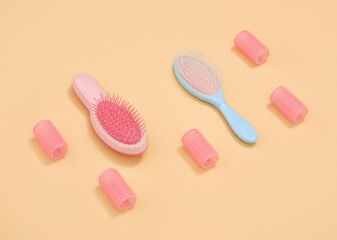 Colorful hair combs and pink curlers. Beauty and care products.