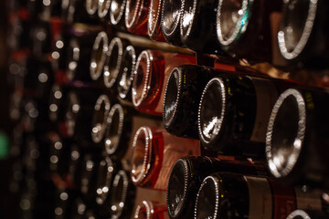 wine bottles in a cellar - obrazy, fototapety, plakaty