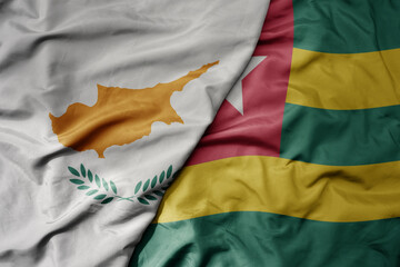 big waving national colorful flag of togo and national flag of cyprus.