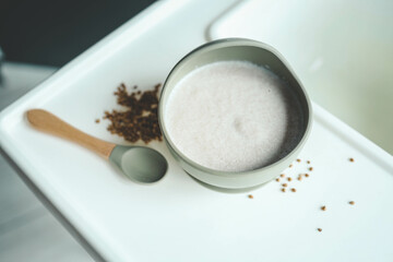 Buckwheat porridge for children in a plate. Feeding children healthy porridge