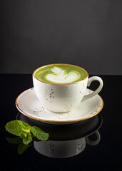 matcha latte in a mug on a black background