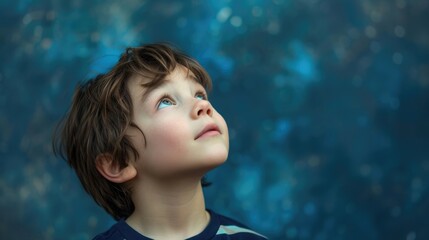 A young boy looking up at the sky with wonder and a hint of sadness as he thinks about the dreams he has yet to achieve.