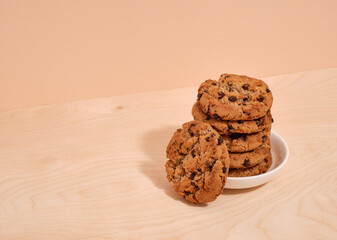 A deliciously healthy cookie with chocolate chunks lies on a white plate. Copy space for text. Healthy breakfast.
