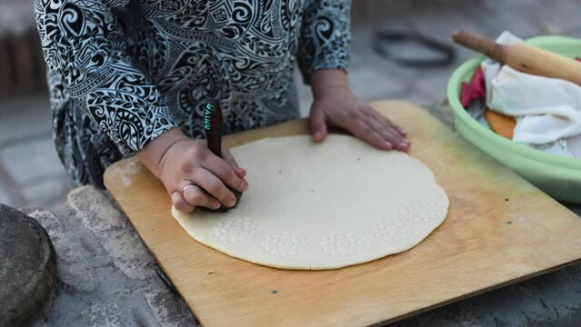 People making bread in tandoor oven in Khiva