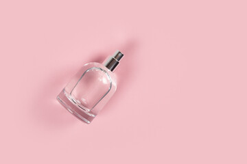 perfume bottle on pink background. copy space for your text