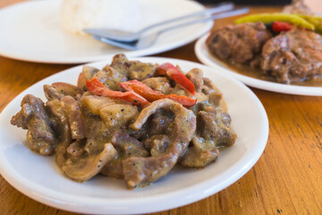 Creamy Pork with Mushroom and Adobong Manok sa Gata served with rice.