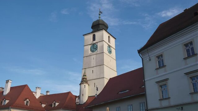 The Council Tower of Sibiu (Turnul Sfatului), Romania, first built in the 12th century in the historic center of the town. Day hyperlapse, architecture, tourism, sightseeing, attraction, travel.