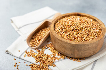 Green buckwheat in a bowl on a wooden kitchen table.Superfood.Raw buckwheat porridge.Healthy vegan food concept, eco products, diet. Copy space.Organic food.weight loss and proper nutrition.