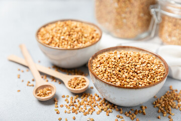 Green buckwheat in a bowl on a wooden kitchen table.Superfood.Raw buckwheat porridge.Healthy vegan food concept, eco products, diet. Copy space.Organic food.weight loss and proper nutrition.