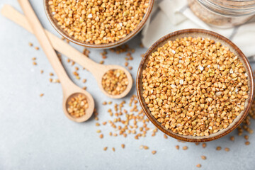 Green buckwheat in a bowl on a wooden kitchen table.Superfood.Raw buckwheat porridge.Healthy vegan food concept, eco products, diet. Copy space.Organic food.weight loss and proper nutrition.