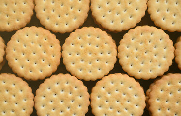 Detailed picture of round sandwich cookies with coconut filling. Background image of a close-up of several treats for tea