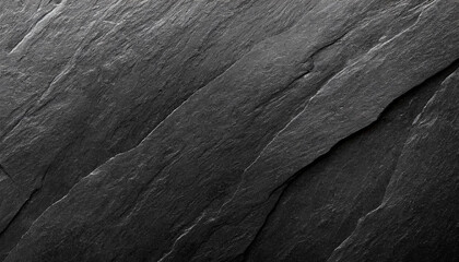 A close-up of dark, rugged rock textures, highlighting the intricate patterns and deep shadows, Ideal for backgrounds, nature themes, or abstract art.