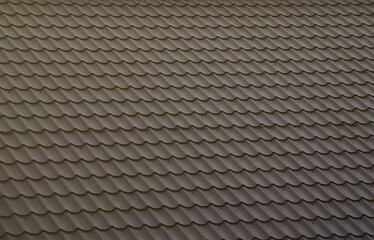 The texture of the roof of painted metal. Close-up detailed view of roof covering for pitched roof. High quality roofing