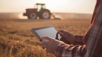 Foto op Aluminium Farmer s hands using tablet in field, tractor and farm in blurred background, copy space. © Andrei