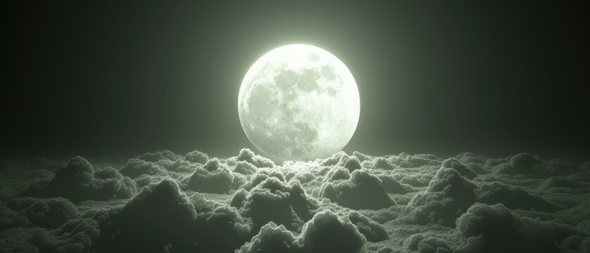 a full moon rising above the clouds in a black and white photo, with a dark sky in the background.