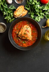 Baked chicken with tomato gravy and herbs