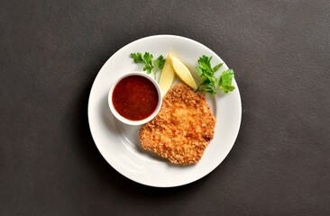 Schnitzel with lemon and leaves of parsley