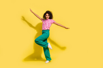 Fototapeta na wymiar Full body photo of cheerful nice lady have good mood clubbing empty space isolated on yellow color background