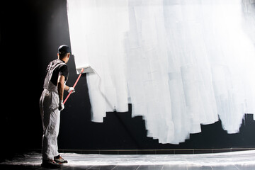Male decorator painting a wall