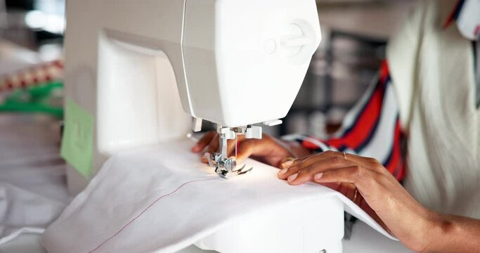 Hands, sewing machine and fabric in studio for manufacturing clothes, small business or production. Person, fingers and equipment in workshop for fashion tailor or ecommerce, pattern or creativity