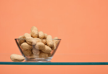 Cashew nuts lying in a glass bowl. A healthy snack. Copy space for text.