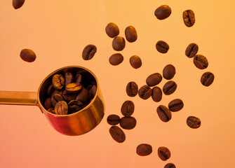 Fresh coffee beans and a golden spoon. Drinking coffee in the morning.