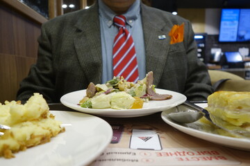 Overdressed man having his filling station dinner in Moscow