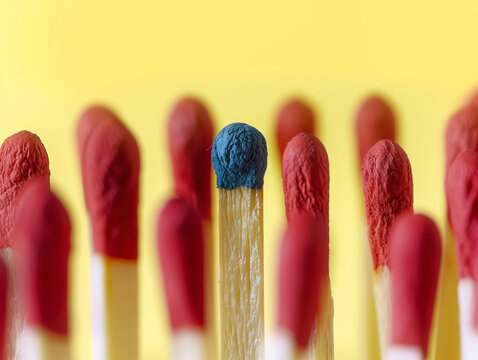 Best Job Candidate. A blue matchstick that stands out among the red matchsticks. Strong contrast in primary colors. Symbolizes leadership or top talent.
