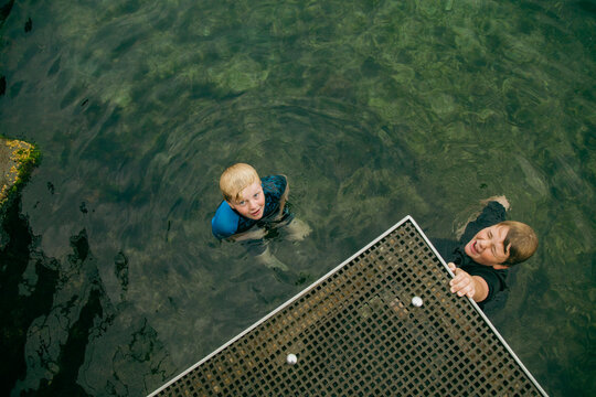 Top view of kids swimming in clear blue water at the Bogey Hole in Newcastle, New South Wales