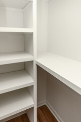 Interior white solid wood closet with wood shelves