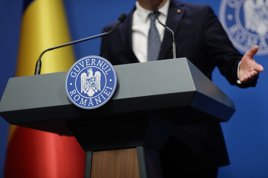 Details with the Romanian Government logo during a press conference held by a minister or politician.