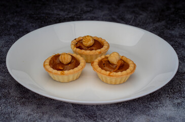 Mini tart. Fresh tartlets with caramel hazelnuts.