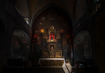 Man Kneeling in Front of Golden Altar