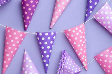 Colorful party flags with polka dots on a purple background.